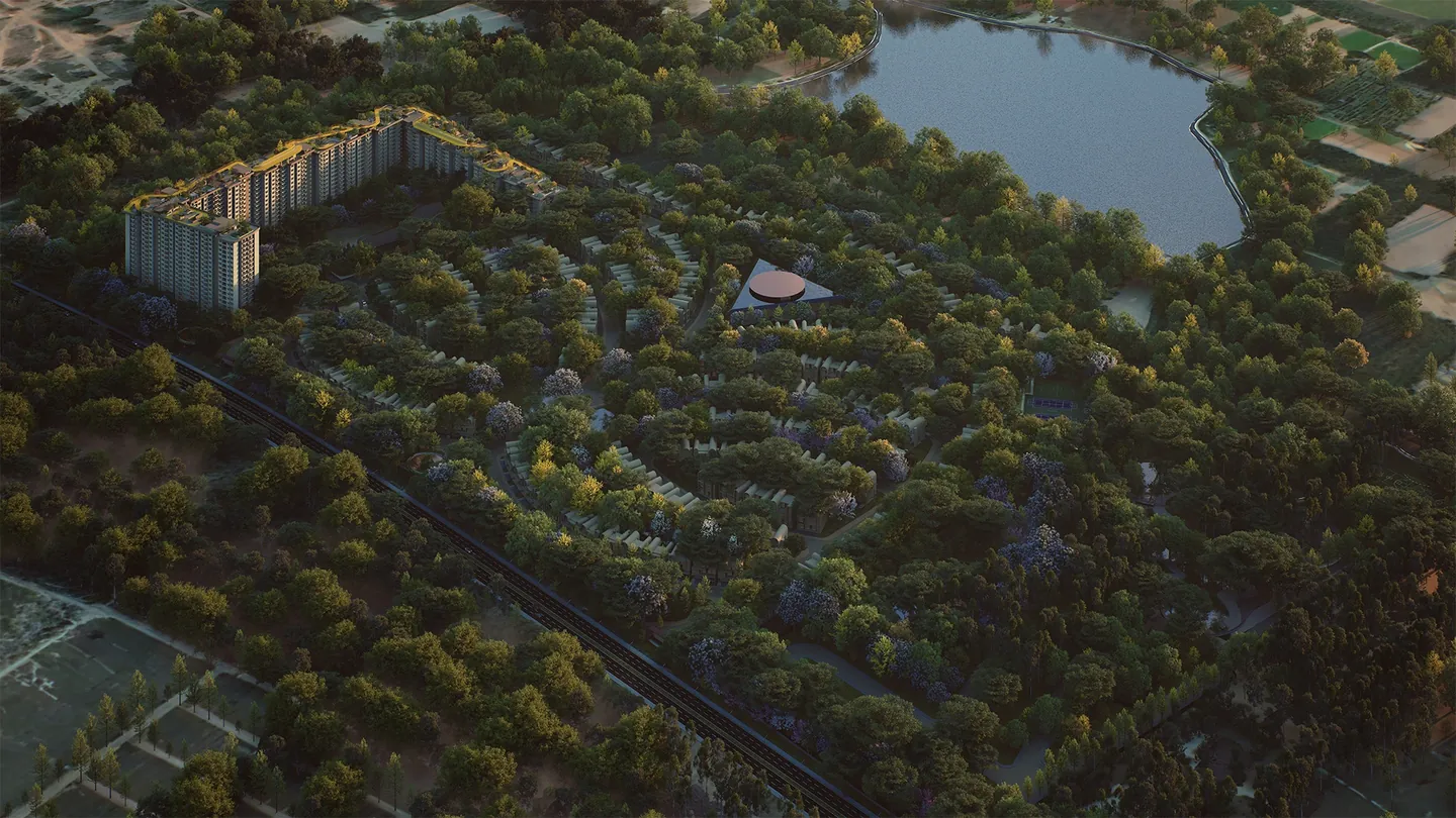 Aerial view of Embassy Origins: the apartment towers, Villa Homes set among forest corridors and the lake beyond